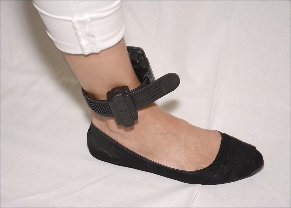 A close up of feet wearing blue and black shoes Description automatically generated