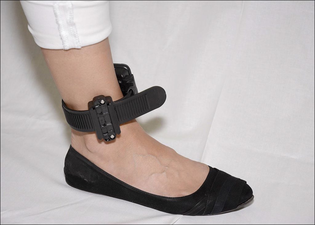 A close up of feet wearing blue and black shoes Description automatically generated