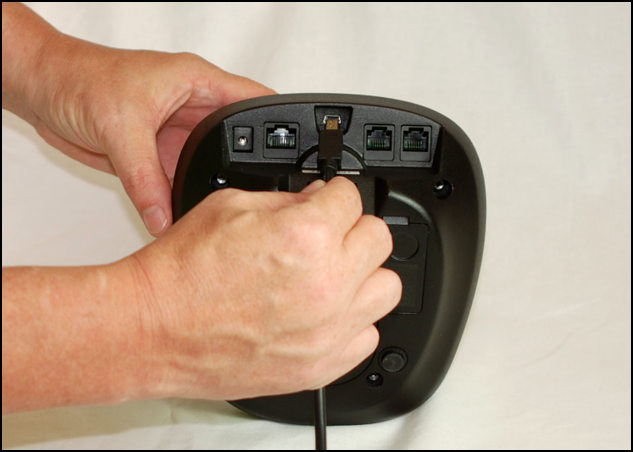 A hand holding a remote control Description automatically generated