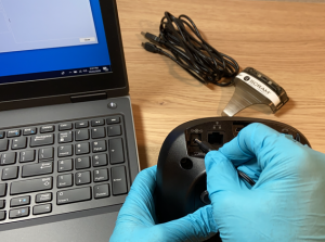 Image of Plugging power cord into the Back of Base Station