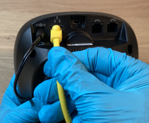 Image of Plugging Ethernet cord into the Back of Base Station (