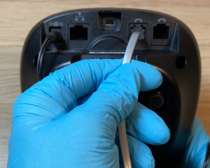 Image of Plugging phone cord into the Back of Base Station