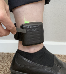 Waking CAM bracelet with magnet, green light on.