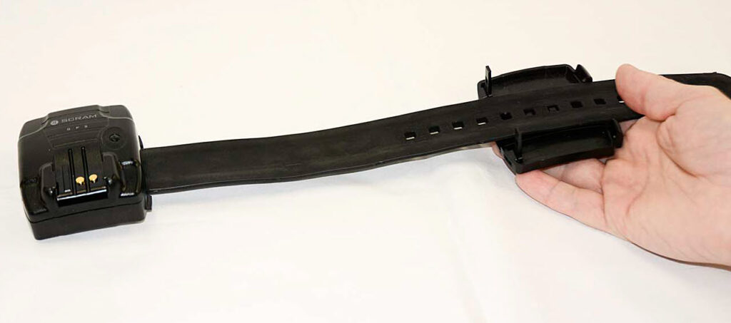 The device strap is laid on top of the device backplate such that the two long posts on the backplate are nearest the device itself, and three notches in the strap align with the three pegs in the backplate. This is correct.